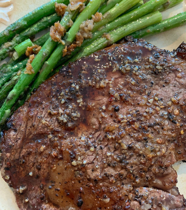 Sautéed asparagus and grilled rib eye steak